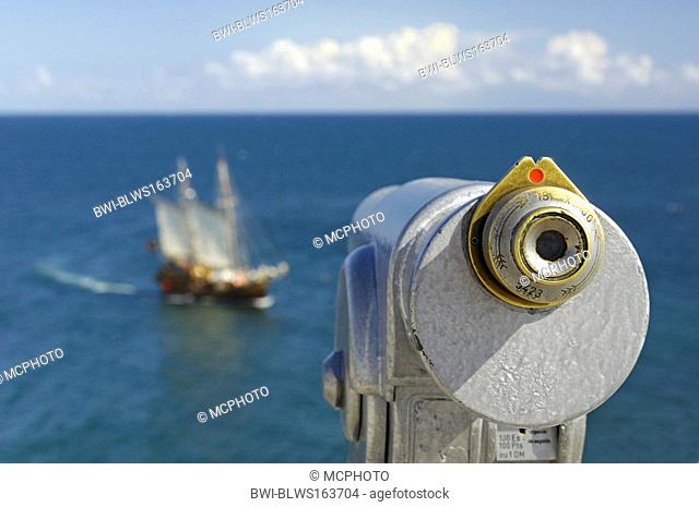 telescope at the coast with a ship