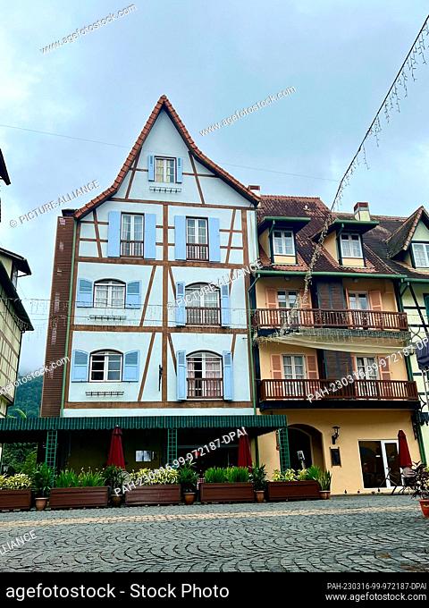 PRODUCTION - 02 March 2023, Malaysia, Colmar Tropicale: View of colorful half-timbered houses in Colmar Tropicale, with the jungle of the Berjaya Hills visible...