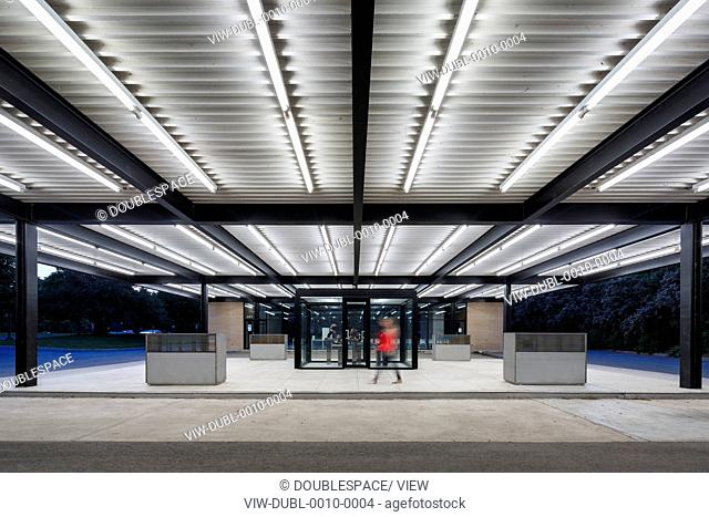 Mies van der Rohe Gas Station, Montreal, Canada. Architect: Architectes FABG, 2011. Person walking under the canopy