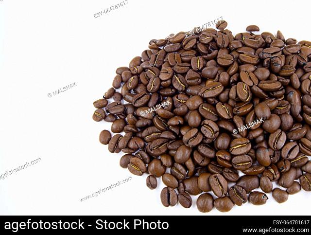 Coffee beans scattered gracefully on a clean white backdrop