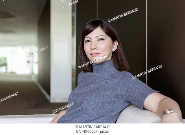 Portrait confident businesswoman on sofa