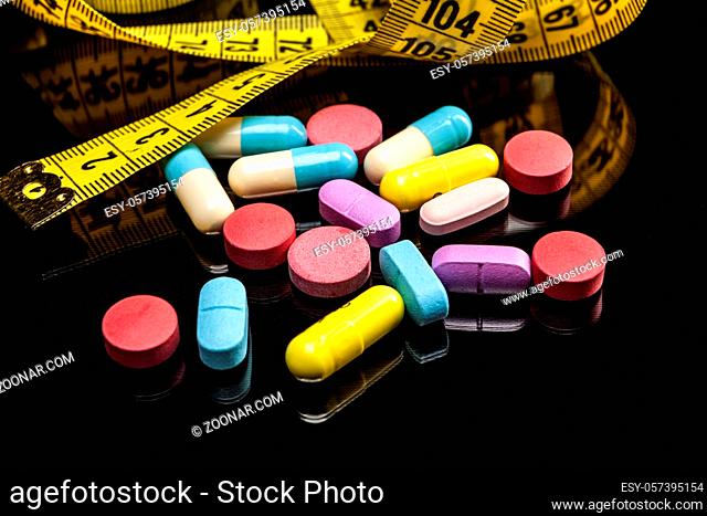 Pills isolated on black background with reflexion