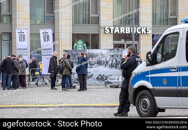 13 February 2020, Saxony, Dresden: Police officers are standing near the information stand of the AfD and the association ""Dresden worthy of commemoration"" on...