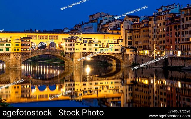 Ponte Vecchio bridge over Arno river in Florence in Italy at dusk