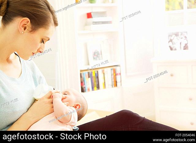 Mother Bottle Feeding Baby Girl