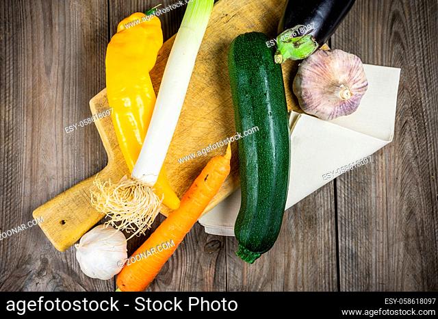 Fresh vegetables ready for cooking shot on rustic wooden table