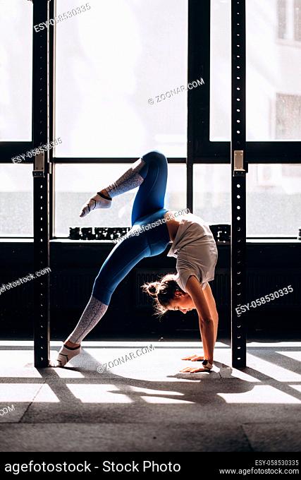 Young woman doing yoga or pilates exercise