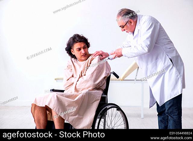 The old male doctor psychiatrist and patient in wheel-chair