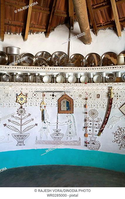 Interior , household utilities placed at decorated circular wall of bhunga house , Kutch , Gujarat , India