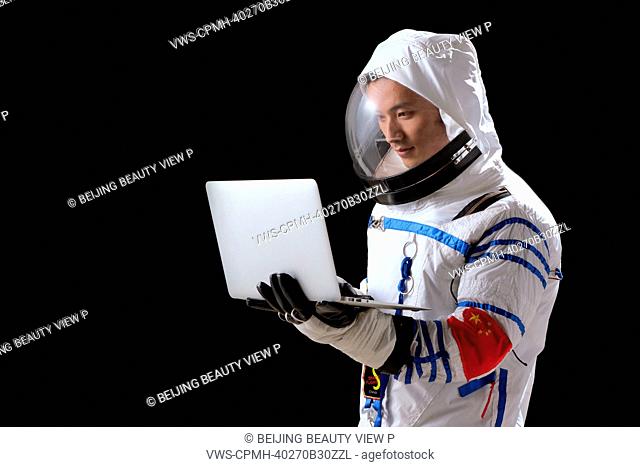Astronaut holding laptop