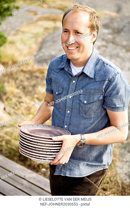 Man carrying plates