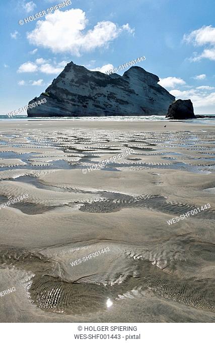 New Zealand, Golden Bay, Wharariki Beach, sand at the beach during low tide and rock