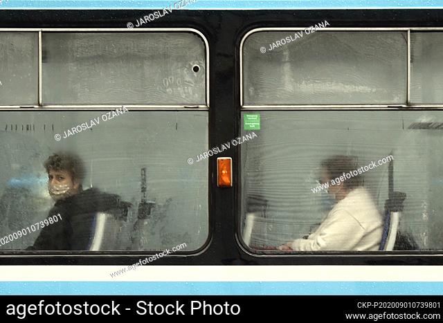 Passengers wear a face masks to protect against the spread of the coronavirus as they sit in a tram in Ostrava, Czech Republic, September 1, 2020