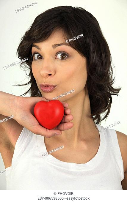 Woman holding up a red heart