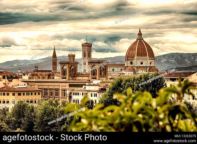 View of famous cathedral Santa Maria del Fiore in Florence and mountains behind it, Italy