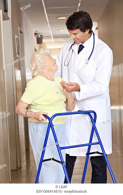 Portrait of elderly woman and doctor with zimmerframe