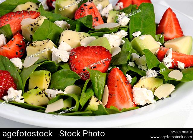 Salad spinach with strawberries, avocado, ricotta and sesame, poppy seeds