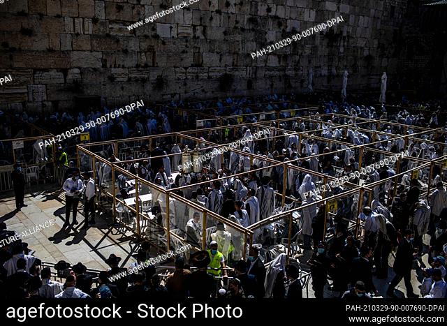 29 March 2021, ---, Jerusalem: Ultra-Orthodox Jews pray in front of the Western Wall, Judaism's holiest site, as they recite the Birkat Cohanim or Priestly...