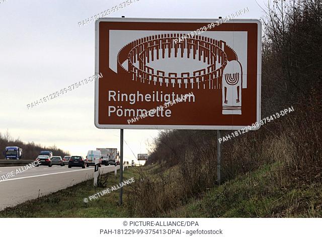 27 December 2018, Germany (German), Pömmelte: Cars drive past a brown-white sign with the inscription ""Ringheiligtum Pömmelte"" on the federal motorway 14