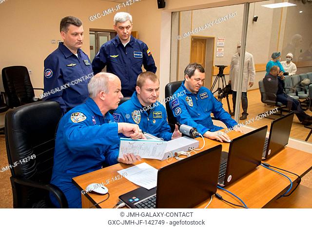 At the Cosmonaut Hotel crew quarters in Baikonur, Kazakhstan, Expedition 47-48 crewmembers Jeff Williams of NASA (left) and Alexey Ovchinin (center) and Oleg...