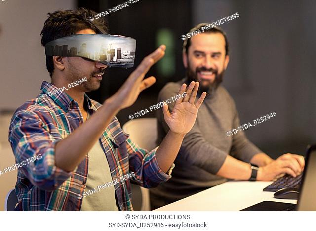 developers with virtual reality headset at office