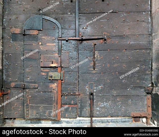 ancient black wooden medieval door with iron locks and bolts on chester cathedral
