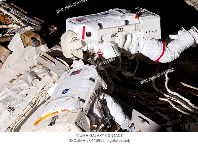 NASA astronauts Andrew Feustel (top) and Greg Chamitoff, both STS-134 mission specialists, participate in the mission's first session of extravehicular activity...