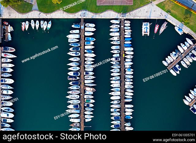 Aerial bird eye view of sailboats and yachts moored in Lovere port, Iseo lake near Bergamo, Italy