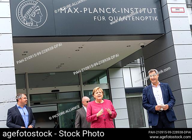 15 September 2021, Bavaria, Garching: Markus Söder (r, CSU), Minister-President of Bavaria, and German Chancellor Angela Merkel stand in front of the building...