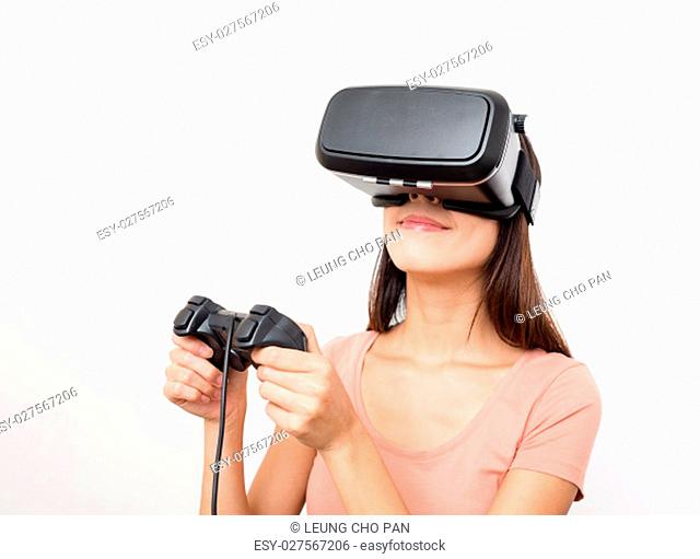 Woman looking though the virtual reality and using joystick