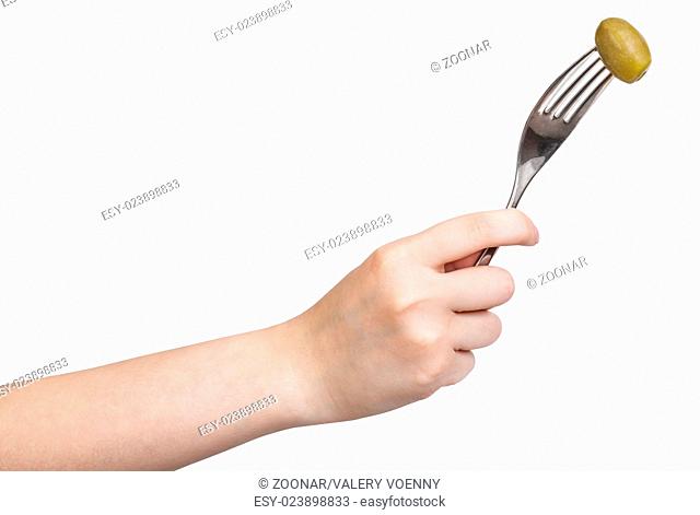hand holding dinning fork with impaled green olive