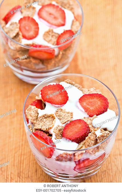 Healthy breakfast of bran flakes with yogurt and strawberries