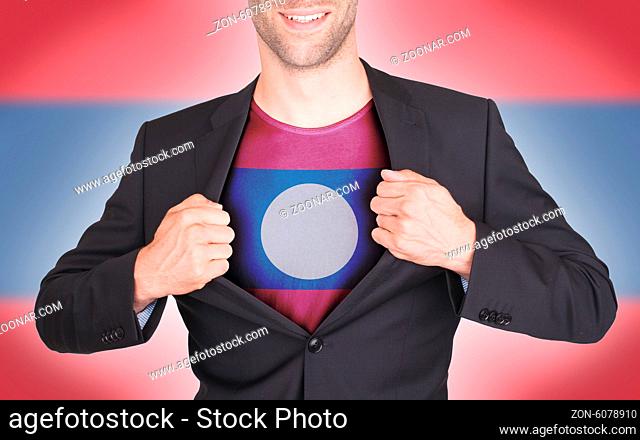 Businessman opening suit to reveal shirt with flag, Laos
