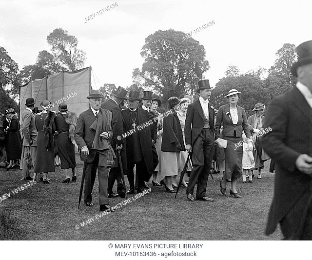 The well-to-do crowd at a cricket match held on 4 June at Eton College, England, including pupils in top hats, well-heeled parents and the college chaplain or...