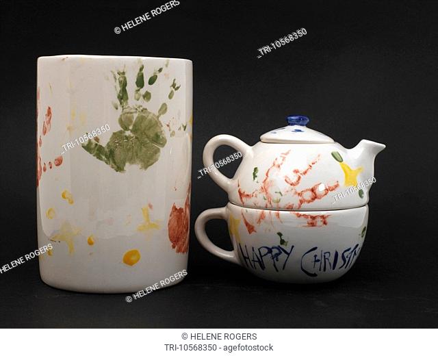 Child Aged Eighteen Months Old Handprints on Teapot and Vase