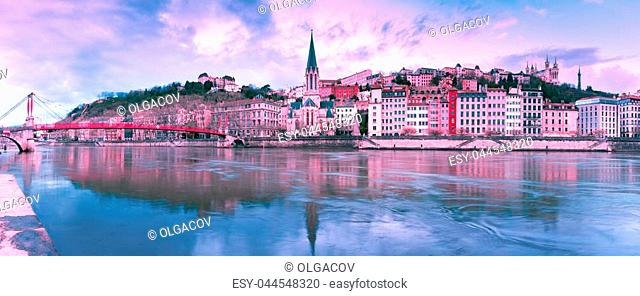Panoramic view of Saint Georges church and footbridge across Saone river, Old town with Fourviere cathedral at gorgeous sunset in Lyon, France