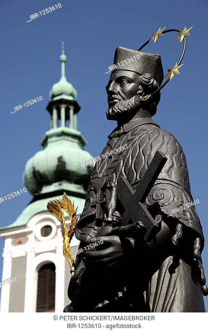 Statue of Saint John of Nepomuk on Lazebnicky Most bridge and St. Jost Church, Ceský Krumlov, Czech Republic, Europe
