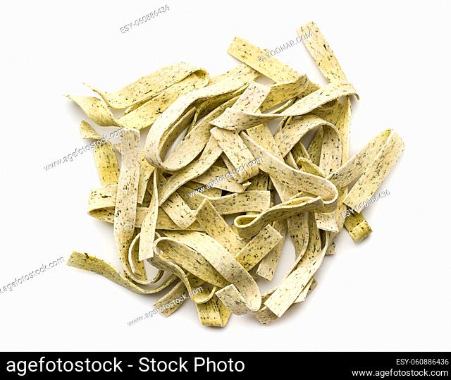 Raw italian pasta. Dry noodles with spinach isolated on white background