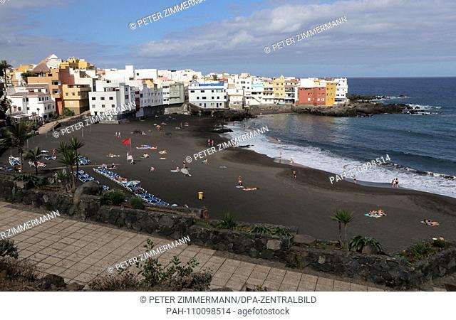 Modern buildings and dark sand on a beach in Puerto de la Cruz on the north coast of the Canary Island of Tenerife, taken on 17.09.2018
