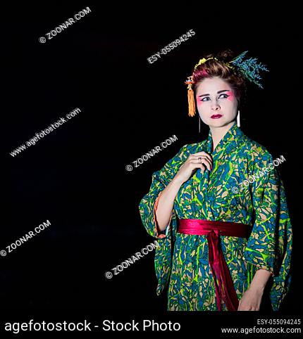 Fine art portrait of european woman in Japanese Geisha style wearing kimono