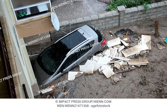 People look at their cars taken by torrential rain in the Black sea town of Varna. Torrential rain following weeks of drought caused severe flooding in Bulgaria