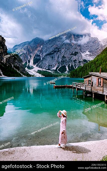girl visit the famous lake Lago Di Braies Italy, Pragser Wildsee in South Tyrol, Beautiful lake in the italian alps, Lago di Braies