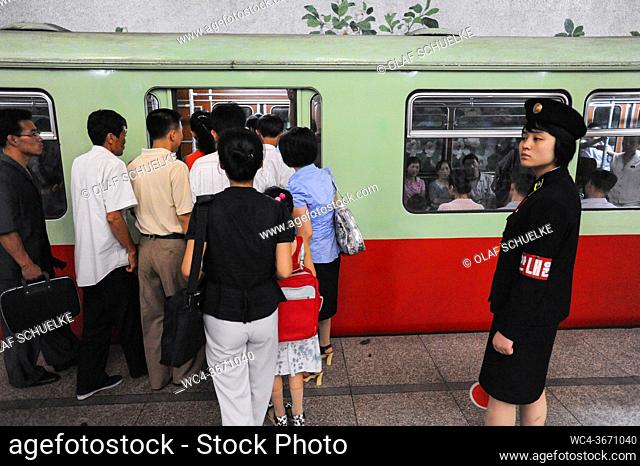 Pyongyang, North Korea, Asia - Commuters board a subway train of the Pyongyang Metro at an underground station in the centre of the North Korean capital city