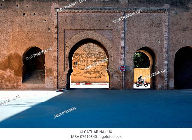 Morocco, royal city Meknes, gate to Rue Maarakat Lahri, moped driver