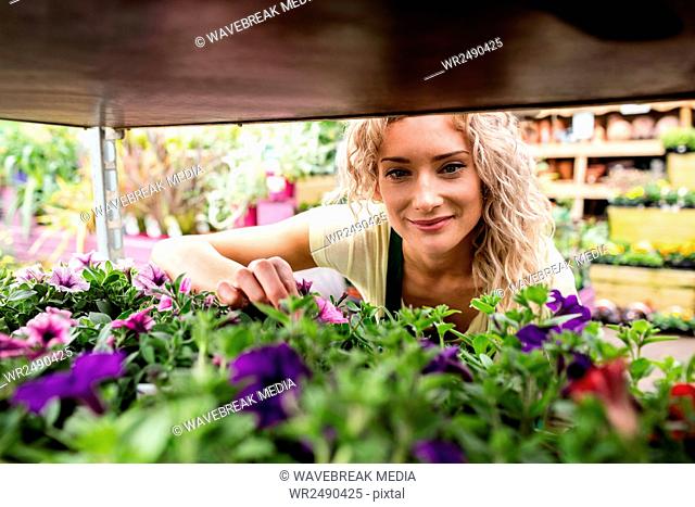 Smiling female florist in garden center