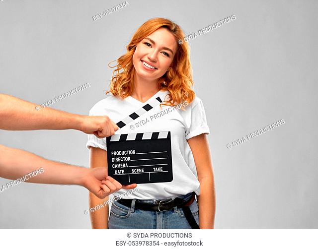 happy woman at studio and hands with clapperboard