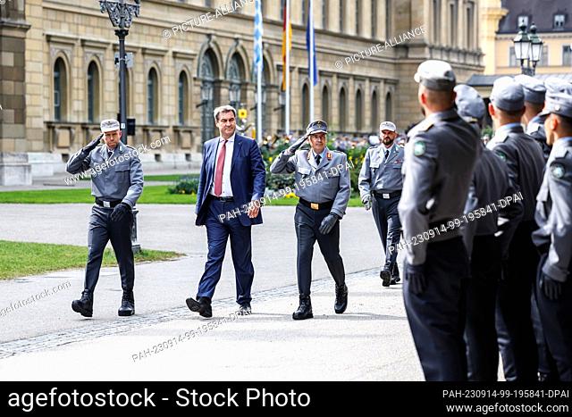 14 September 2023, Bavaria, Munich: Markus Söder (CSU, M), party chairman and prime minister of Bavaria, strides down the ranks of recruits from Mountain...