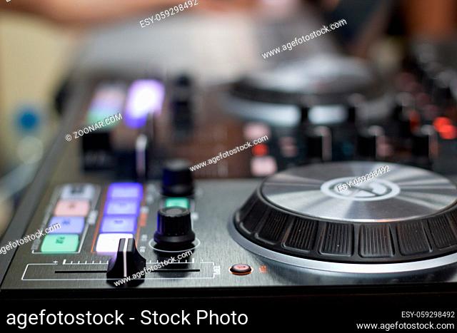 remote and mixer DJ for music, blurred background