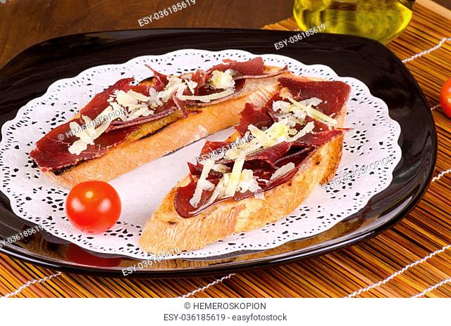 Traditional Spanish pintxo with air dried beef meat and cheese