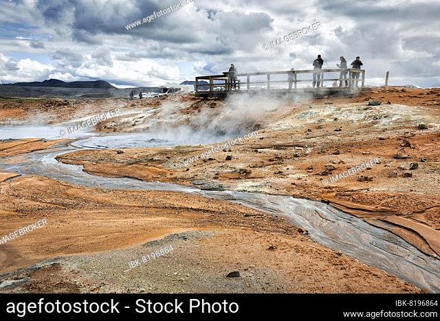 Tourists on viewing platform at steaming mud pot, Hverarönd geothermal area, also Hverir, Namaskard or Námafjall, Mývatn, Krafla volcano system